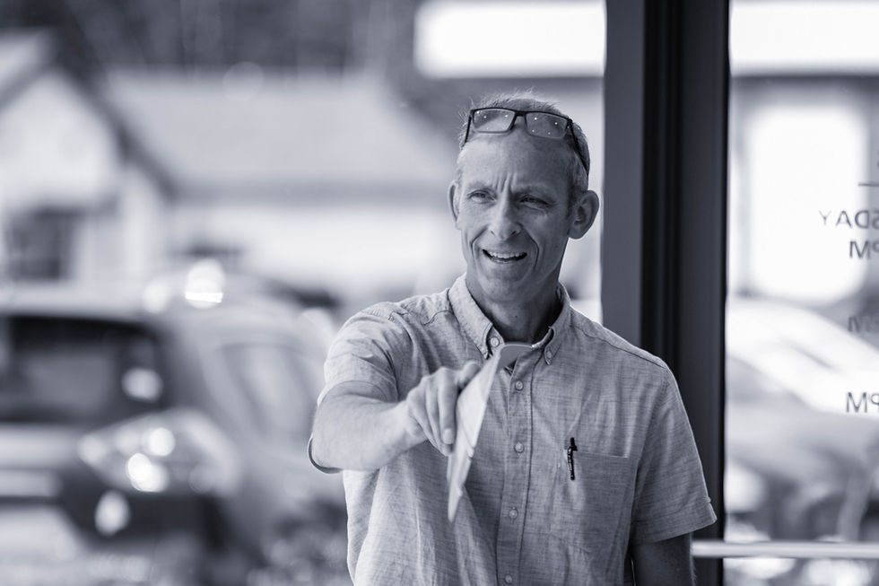 A CBC employee happily working on some custom creative for a dealership partner.