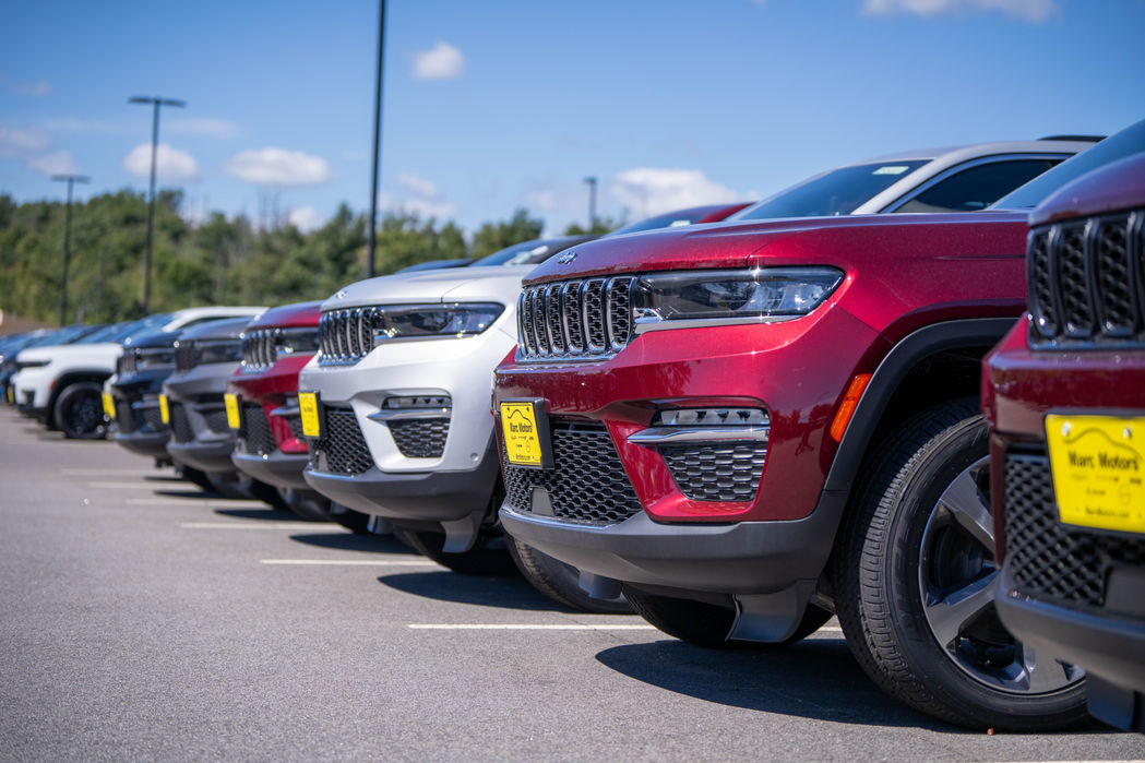 A line up of Jeep vehicles on a dealership lot posed for a custom photography shoot.