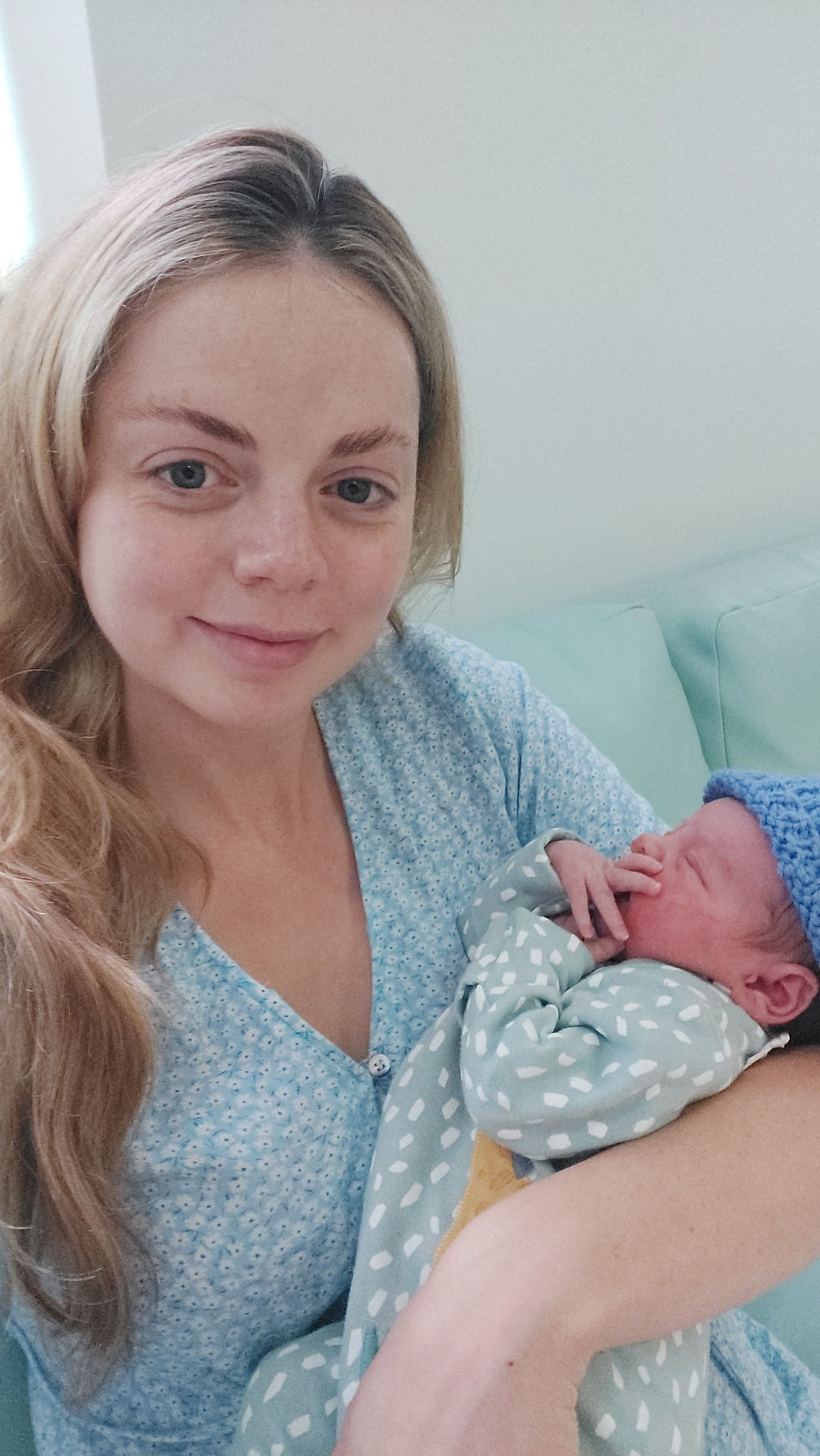 A post partum woman holds her newborn baby after water birth at RVI Birth Centre Newcastle