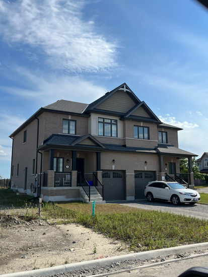 Large two-story house with two garage doors and an SUV