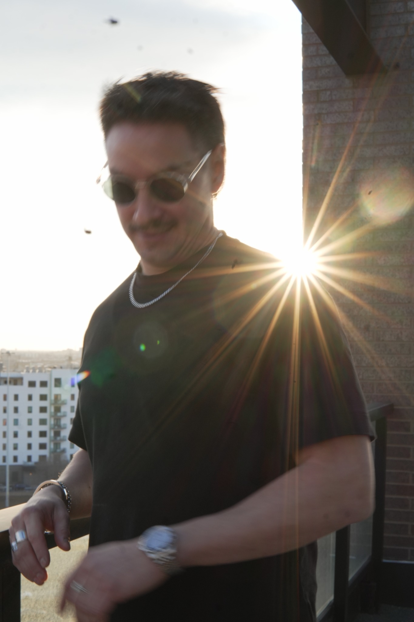 Tempo founder wearing a wristwatch on a Chicago balcony