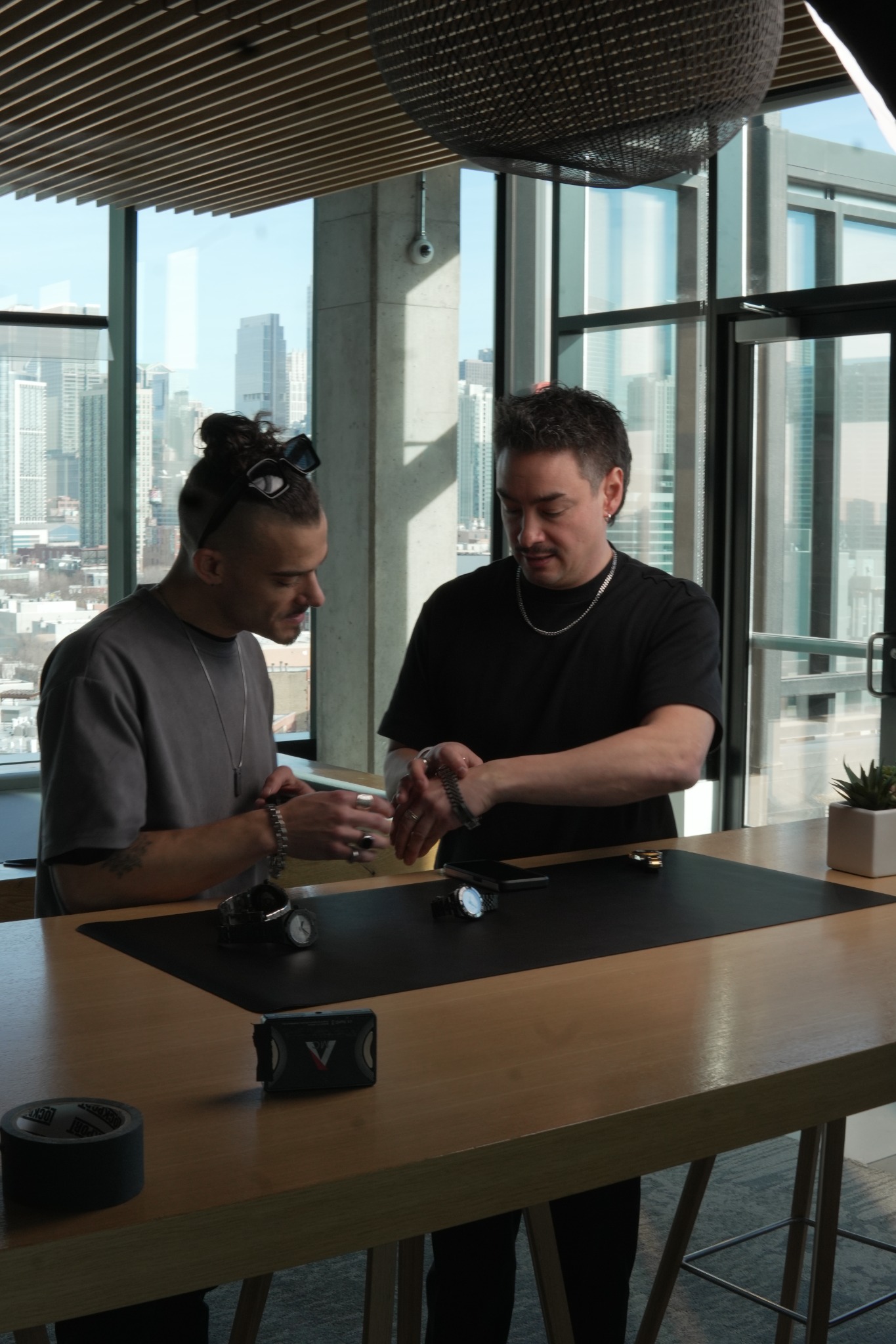 Tempo founders examining watches in a Chicago high-rise setting