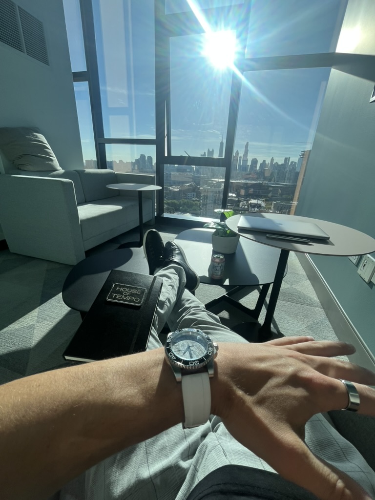 House of Tempo notebook and watch in a high-rise lounge