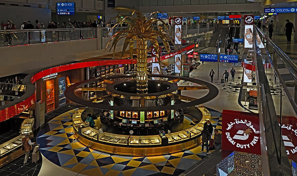 The golden palm tree sculpture and Dubai Duty Free in DXB Terminal 3.