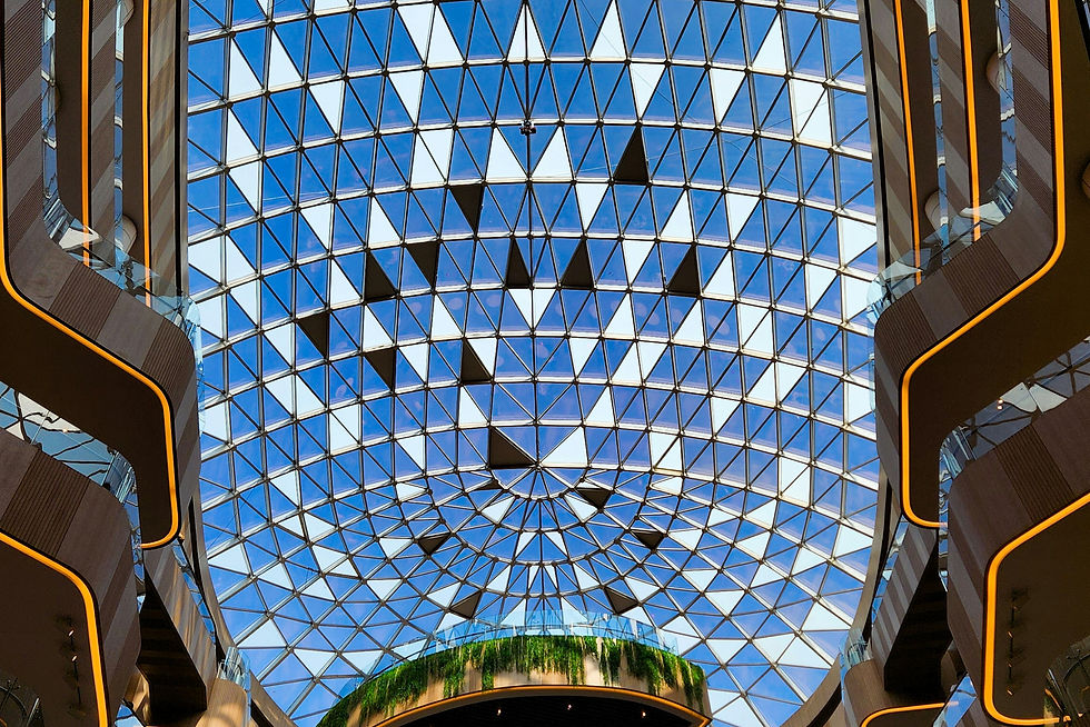 the ceiling of a shopping mall with a blue skylight