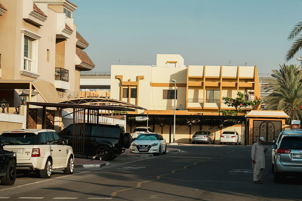 A quiet villa neighbourhood street in Dubai with parked cars.