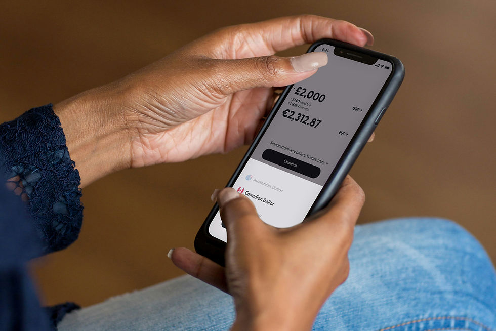Hands holding a smartphone using a banking app to transfer money.