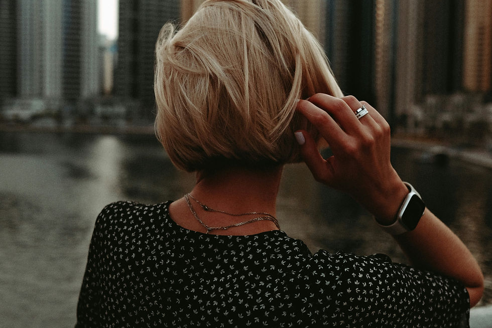 a woman standing on a bridge talking on a cell phone