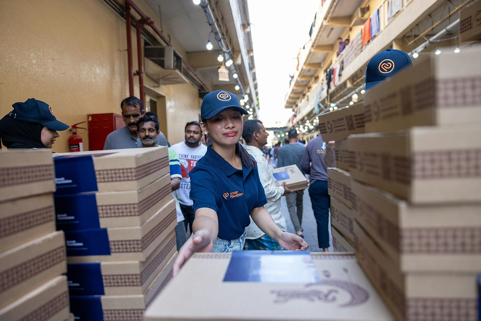Woman in uniform handling boxes in a warehouse