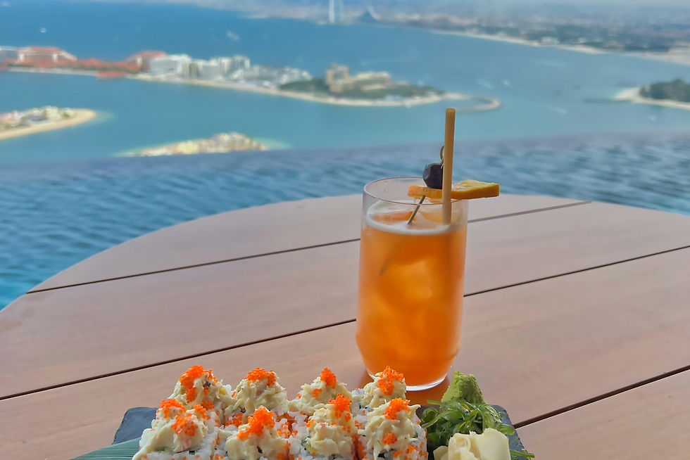 Sushi and a coctail with the view of Downtown Dubai seen from the AURA SKYPOOL