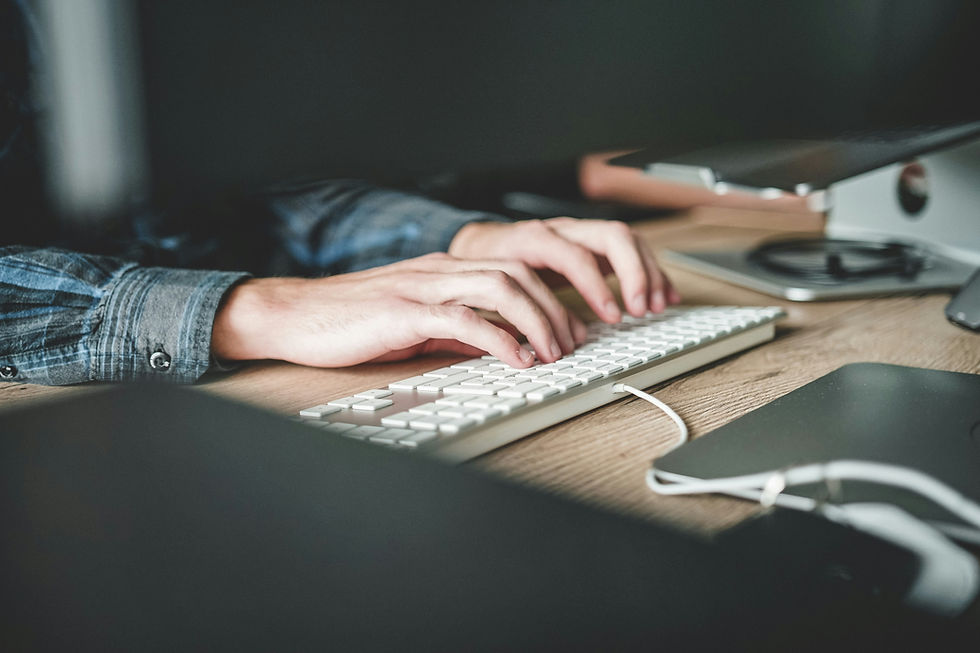 Hands typing on a keyboard while signing up for an online course