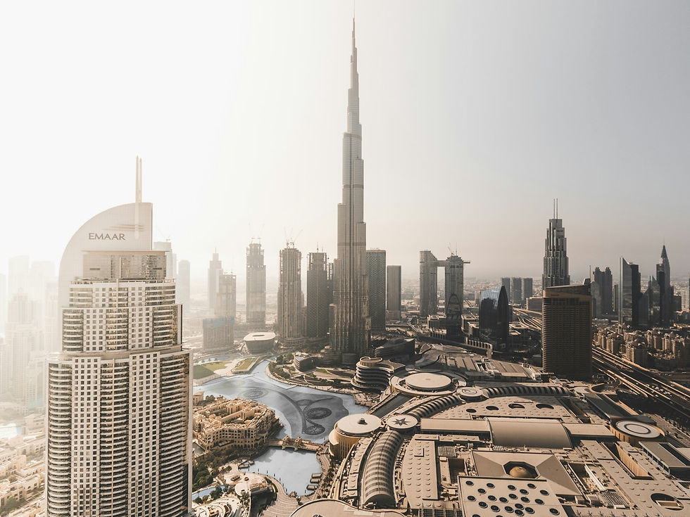Aerial view of Downtown Dubai with the Burj Khalifa and Dubai Mall by day.