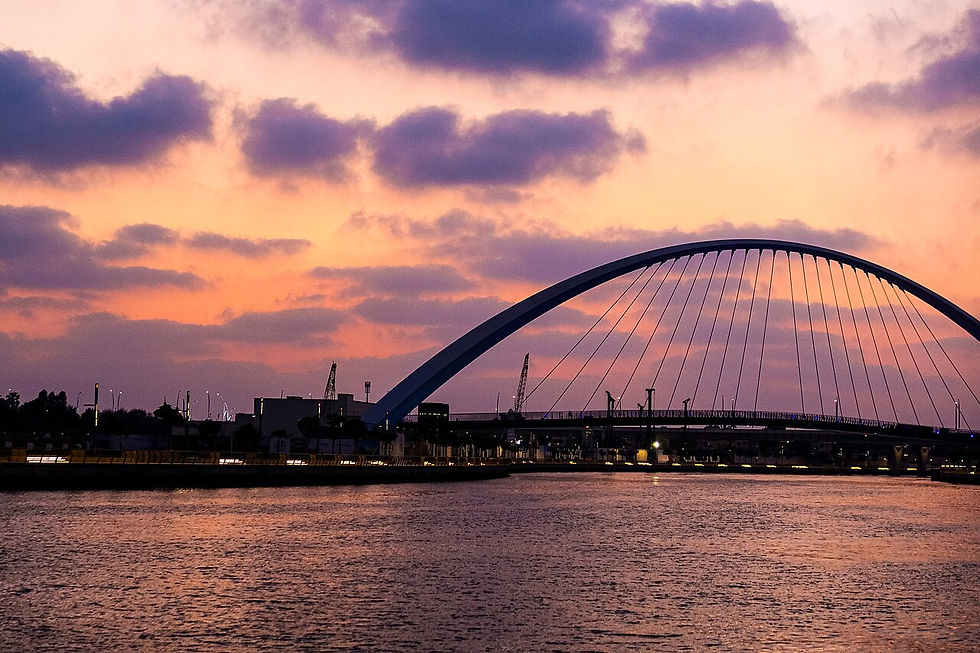Dubai Water Canal at sunset with Business Bay towers