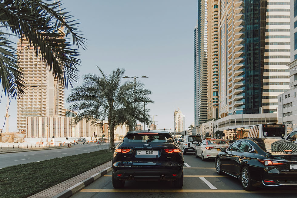 Traffic jam in Dubai Marina district with modern skyscrapers and palm trees