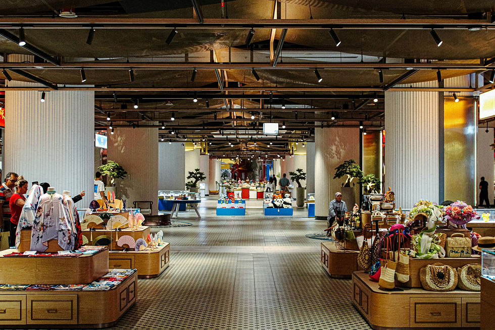 A glimpse inside the Chinatown of Dubai Mall, featuring small shops and sellers with traditional Chinese products, clothing, and bags.