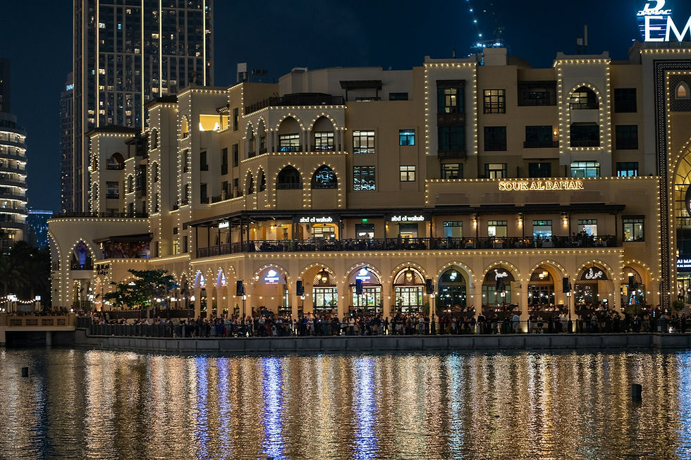 Souk Al Bahar Dubai at night — an iconic food and dining destination lit up with restaurant terraces along the waterfront