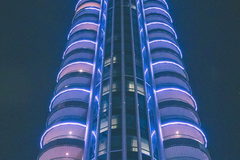 a tall building lit up with blue lights