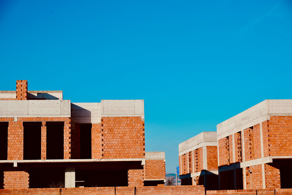 Buildings under construction against a clear blue sky.