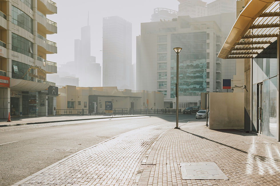 Curved street sidewalk with modern buildings, hotels and sun reflections in a metropolitan area