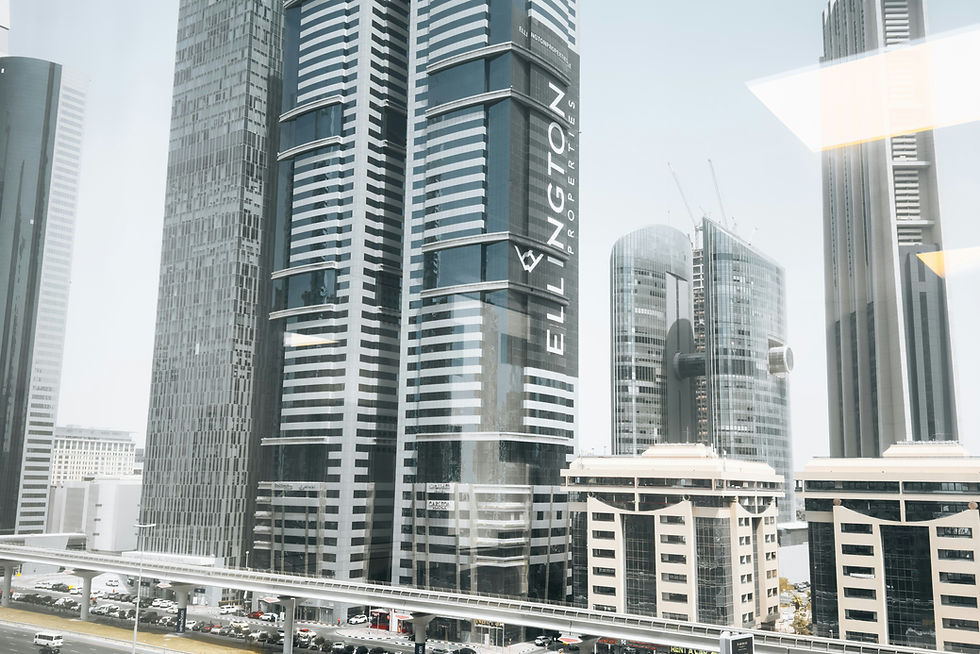 Iconic Ellington Properties skyscrapers on Sheikh Zayed Road in Dubai, with heavy traffic and futuristic urban skyline.