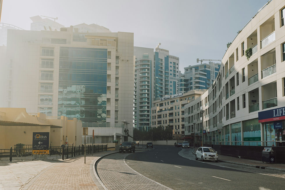 Curved street sidewalk with modern buildings, hotels and sun reflections in a metropolitan area