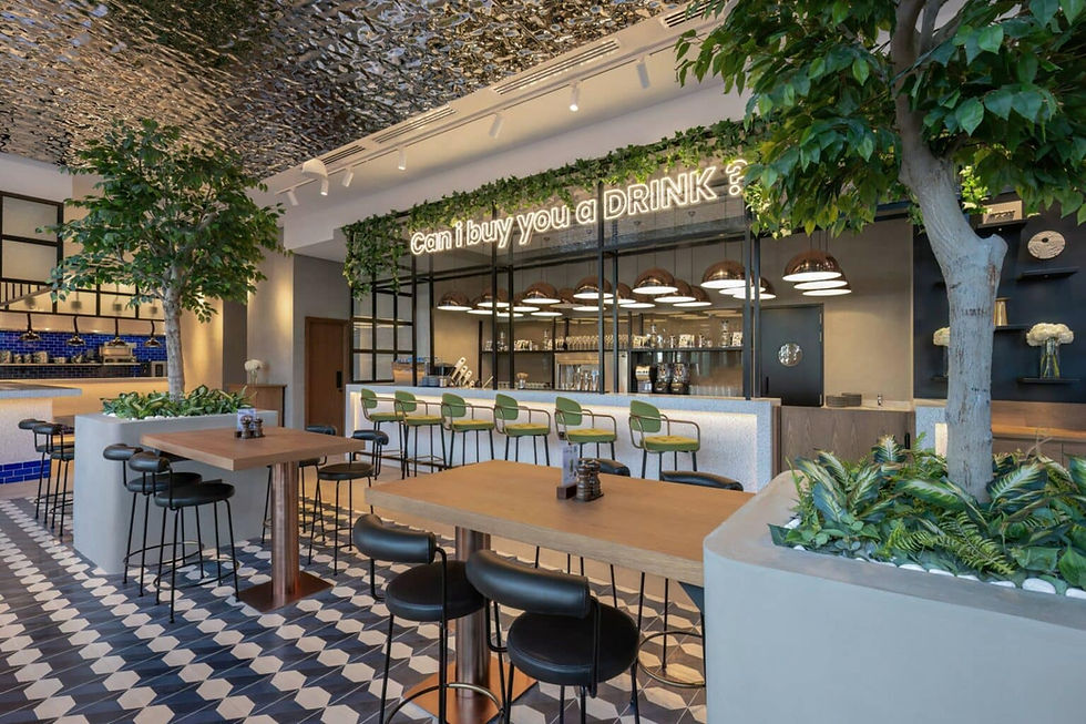 Jones the Grocer bar and indoor dining room — copper pendant lights, geometric tile floor, and the 'Can I buy you a drin