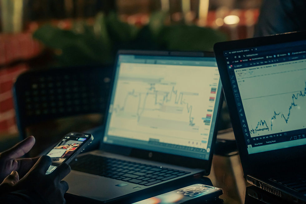 People working on laptops with financial charts at night