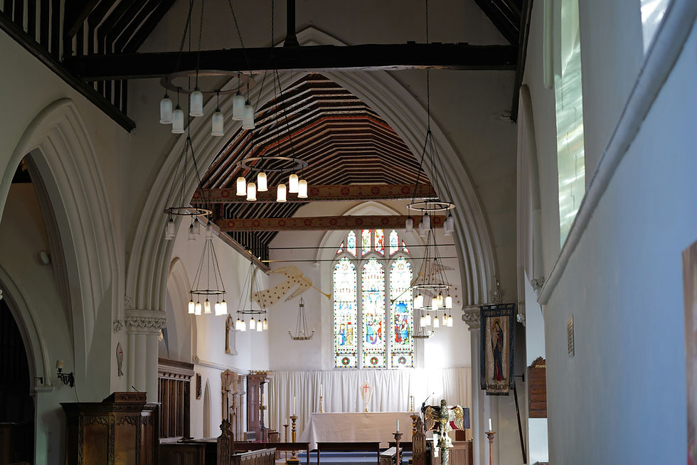Interior view of a church with pews and stained glass.