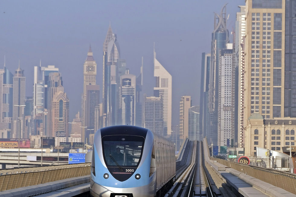 Skyscrapers of Dubai as backdrop with a Dubai Metro train.