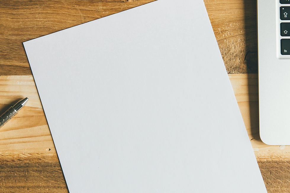 Digital creative desktop with blank white paper pen and laptop