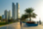 Abu Dhabi Corniche Park promenade at sunset with twin towers in the background