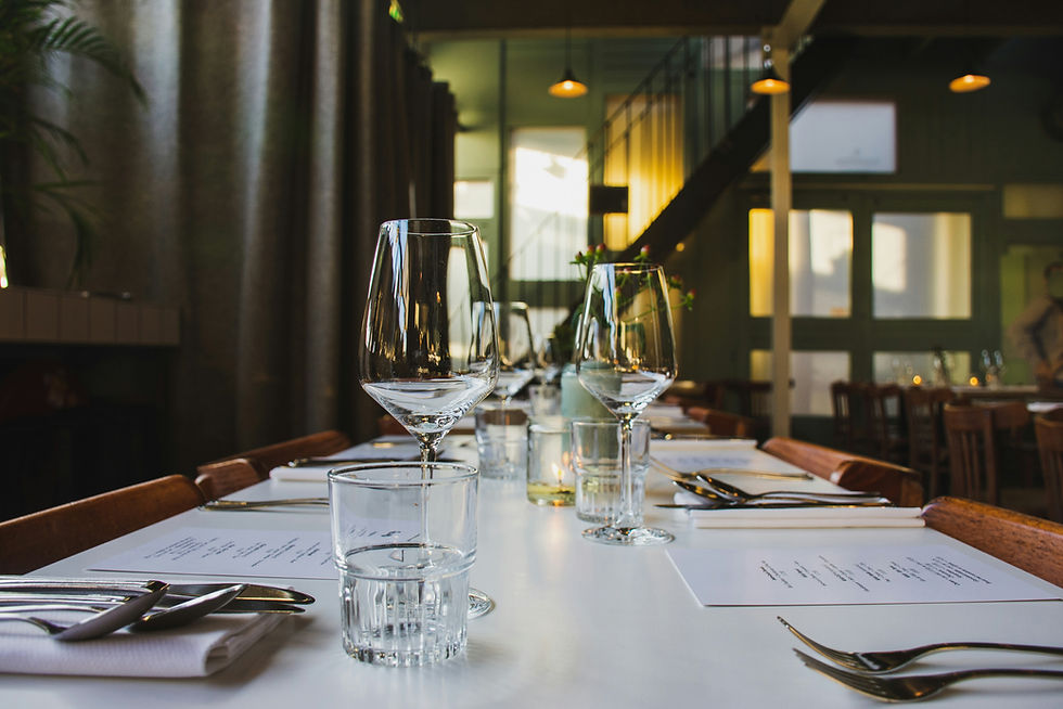 A Set dining table with wine glasses on the table.