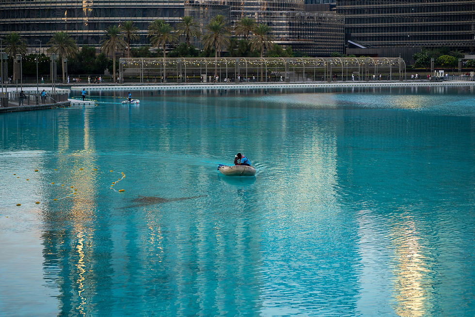 A person in a small boat in a large body of water