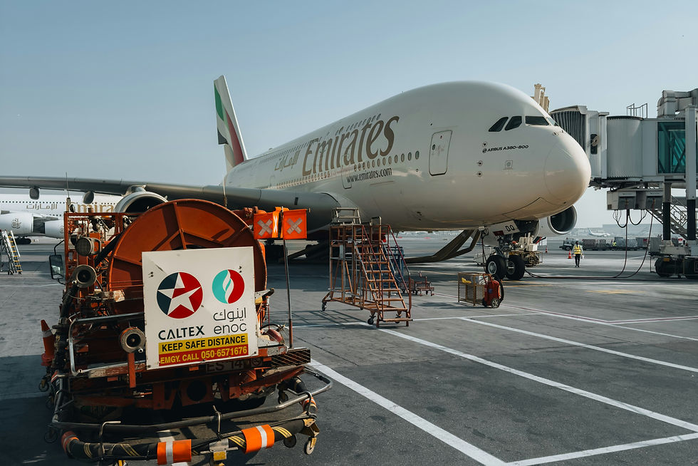 Commercial airplane parked at an airport gate during daylight, viewed through terminal glass. A modern aviation scene representing travel, logistics, transportation, and global mobility. Ideal for bus