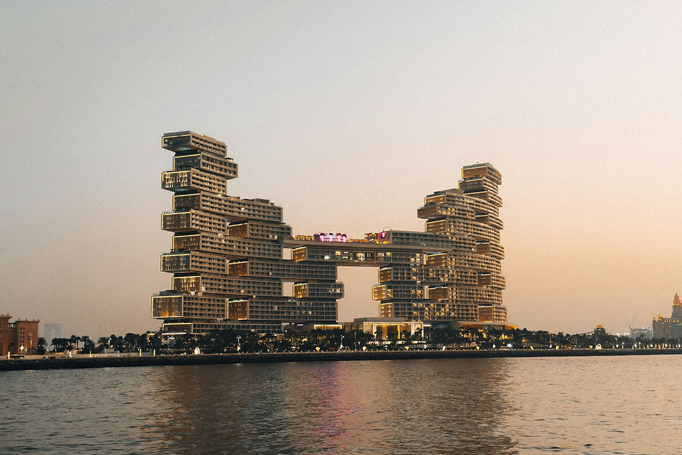 Atlantis The Royal in Dubai photographed from the water at sunset, highlighting its iconic stacked architecture and luxurious resort presence on Palm Jumeirah.