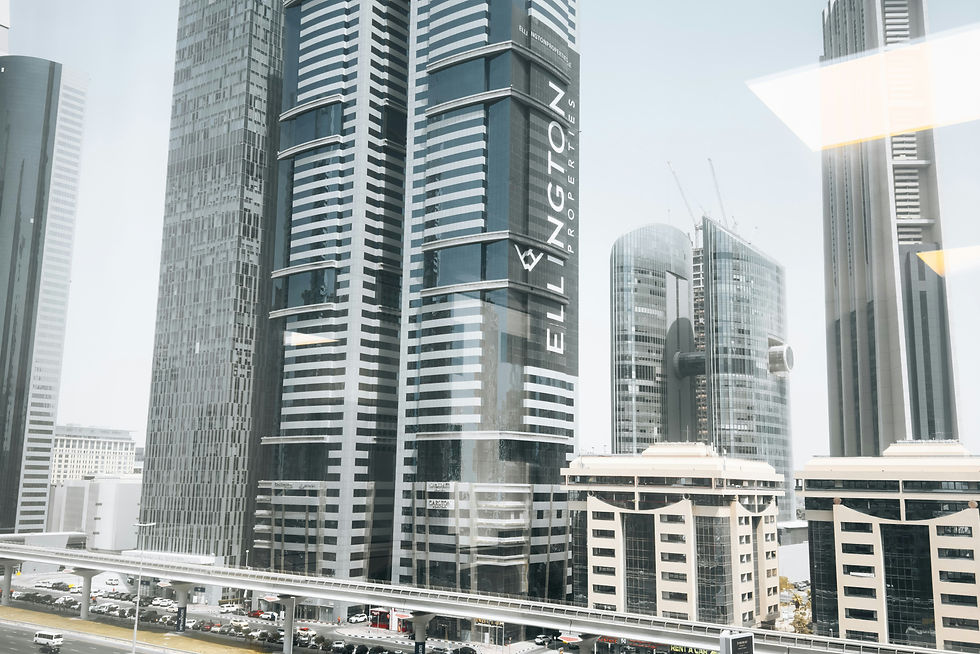 Iconic Ellington Properties skyscrapers on Sheikh Zayed Road in Dubai, with heavy traffic and futuristic urban skyline.