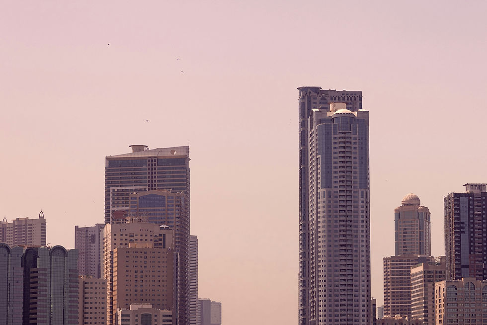a large body of water with tall buildings in the background