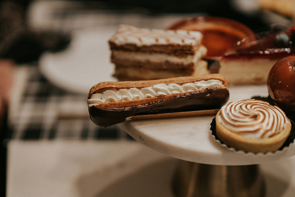 A selection of gourmet pastries and desserts on a stand — representative of Café Bateel patisserie offerings