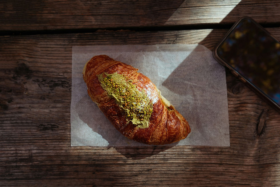 A croissant sitting on top of a piece of wax paper