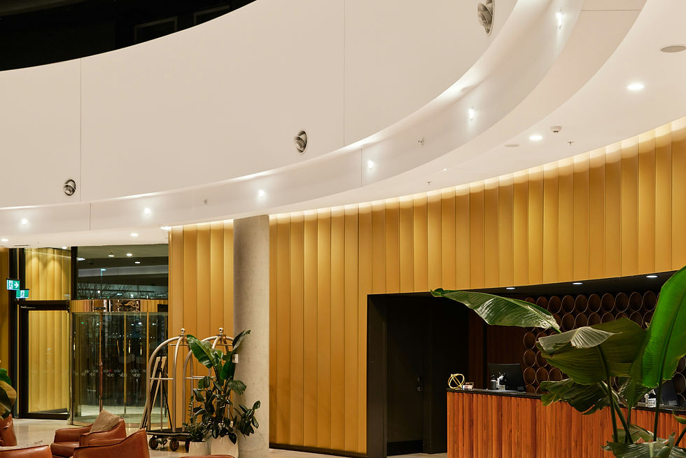 Modern hotel lobby with leather chairs and reception desk.