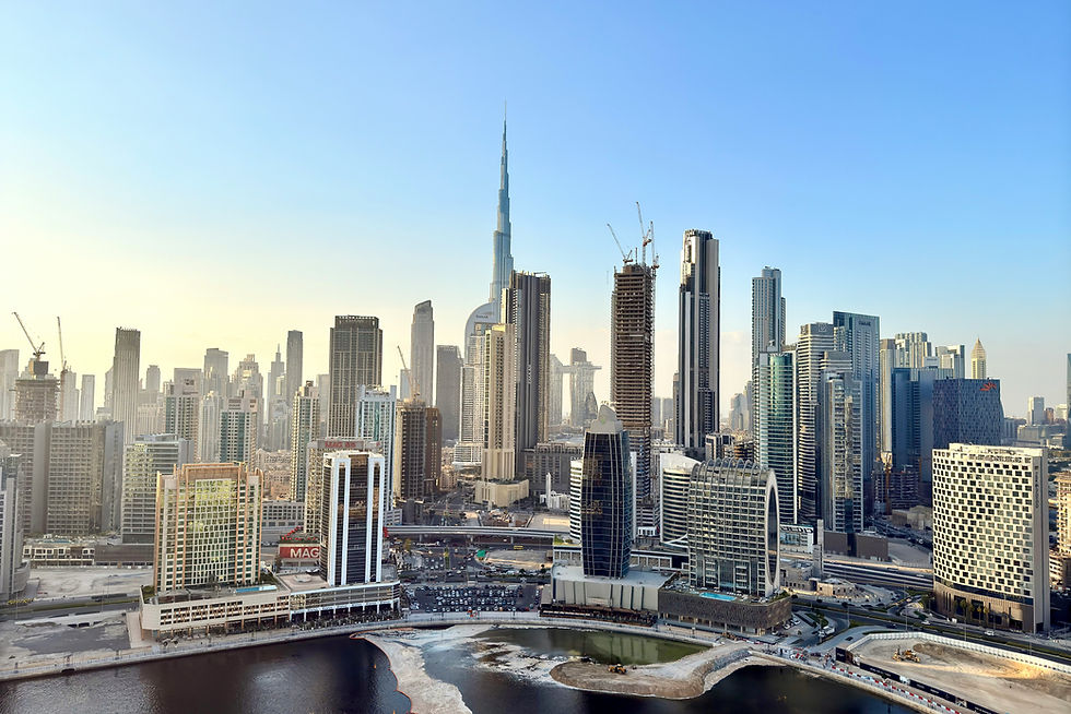 Iconic City Skyline: A breathtaking daytime view of a world-famous skyline, featuring the tallest building on Earth amidst a forest of modern skyscrapers. The waterfront in the foreground reflects the