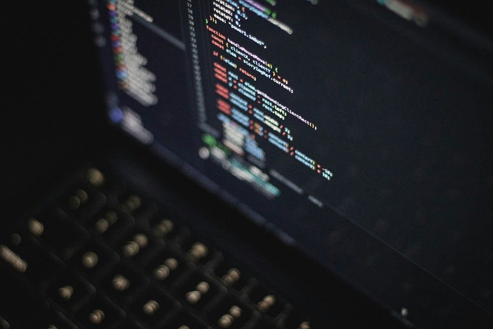 Focused close-up of colorful programming code on a laptop screen, modern software development workspace at night