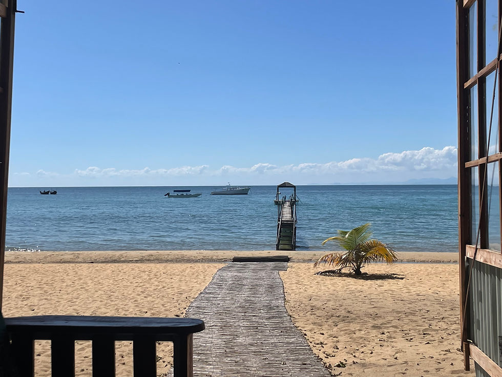 View of Lake Malawi from a beachfront lodge, boats moored offshore