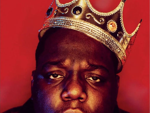 The Notorious B.I.G. with a crown on his head is in the picture