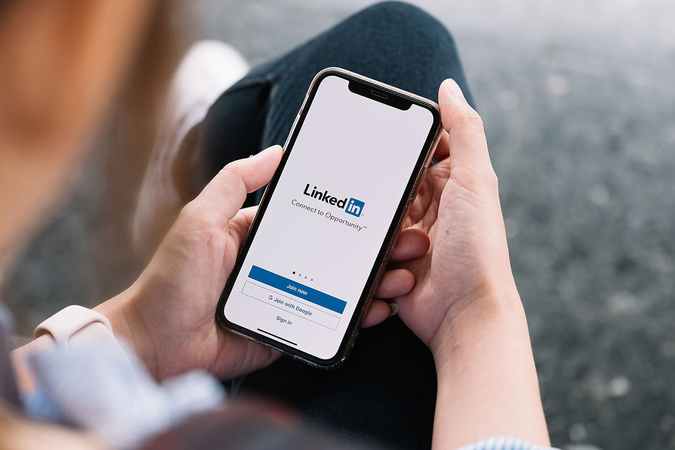 Woman opens the LinkedIn app on her smart phone.