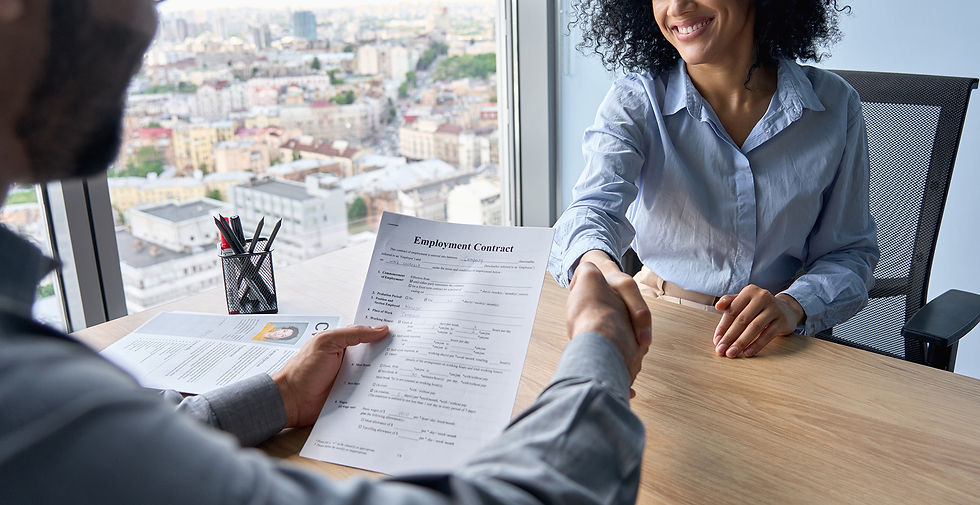 Closeup of person holding employment contract job offer hiring welcoming female worker manager shaking hands in contemporary office. Human resources concept.
