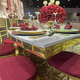 Elegant table setting with red roses and gold accents.