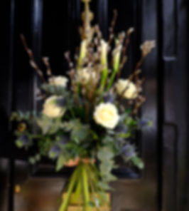 Tall & elegant Christine, a combination of Calla lilies, Avalanche roses Blue Eryngium & seasonal foliage.