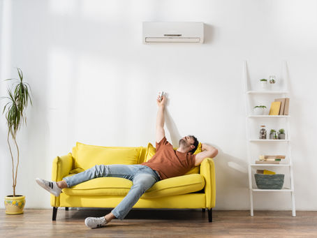 Man adjusting mini split air conditioner.
