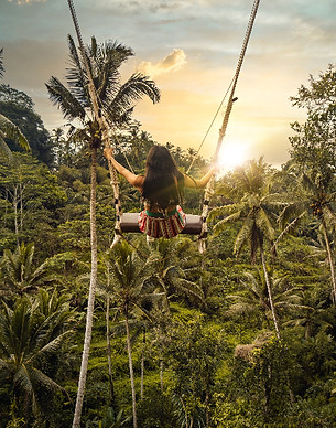 Bali jungle swing surrounded by tropical rainforest and luxury island experiences